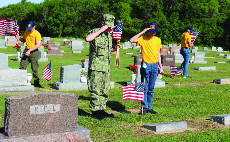 U.S. Naval Sea Cadets SN Zane Finkenbinder and Recruit Carver Conkling salute the grave of WWI veteran William Garsee, as SR Mehmet Akkus, far left, and SR Zackery Henderson look for more veterans' graves at Tecumseh Cemetery on May 17. See full cutline below. Natasha Dunagan, Countywide & Sun