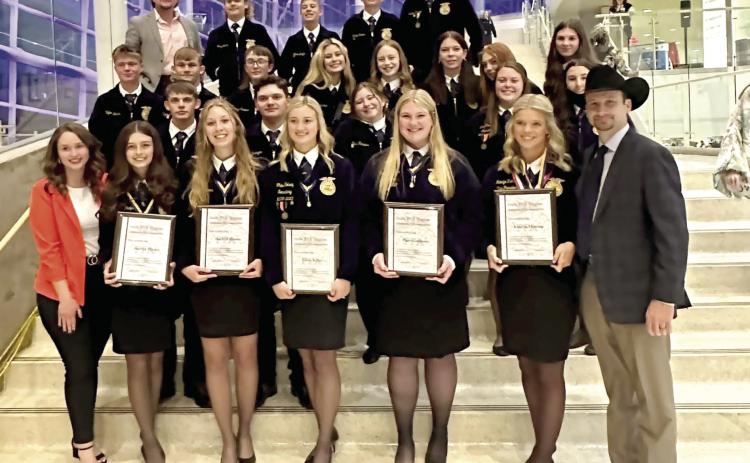 On May 2-3, 24 Tecumseh FFA members attended the Oklahoma State FFA Convention in Tulsa, and five received their State FFA Degrees, according to the Tecumseh FFA Facebook page. Posing with their fellow members and Advisors Mara Carman, far left, and Dodge Nichols, far right, they are Jocelyn Phelps, Marli Williams, Chloe Kelsey, Piper Goodson and Katelyn Fleming. Photo provided.