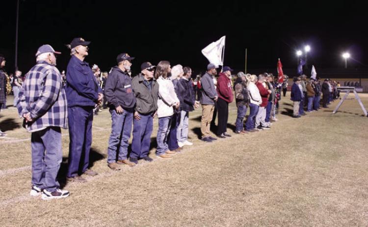 At least 30 veterans participated in the 'veteran's parade' where they were announced by Tecumseh High School Assistant Band Director Bailey Vaughn and stood on the THS football field to listen to their service theme songs. This was part of the Veteran's Day Light Show, coordinated by Band Director John Outon, who also invited the Meeker and North Rock Creek High School bands this year. Photos by Natasha Dunagan, Countywide &amp; Sun