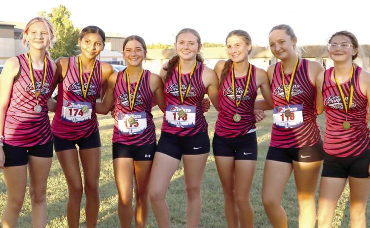 The Tecumseh Cross Country Lady Savages competed at the Savage Cross Country Invitational at Tecumseh High School on Sept. 22. Shown, from left, are Brynna Walker, 18th place; Livia Four Horns, eighth place; Bree Mitchell, seventh place; Allison Walker, first place; Sosi Mitchell, second place; Anna Harvey, 21st place; and, Kate Pearcy, sixth place. Photos courtesy of Amiah Vermillion, THS student