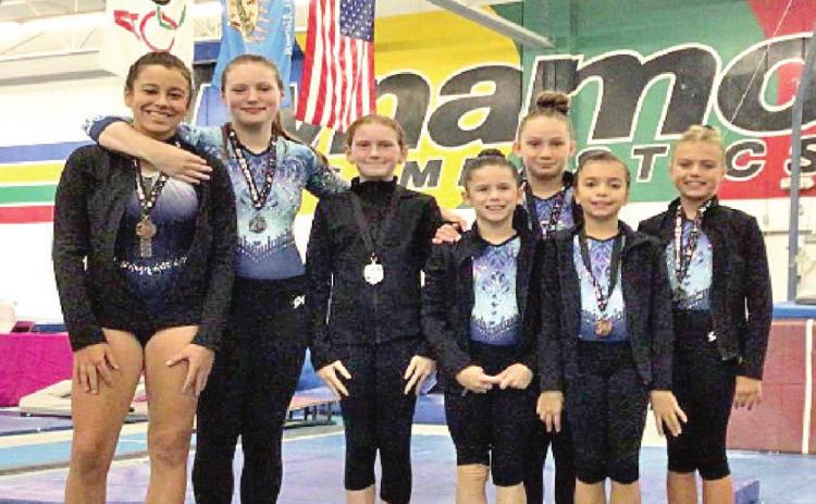 Level 4/5 gymnasts pictured above (from right) are Ocean Minor, Karlee Linn, Juliet Troutz, Rilynne Roberts, Kassidi Lowden, Aria Griggs, and Kashyrah Chavez. Photo provided