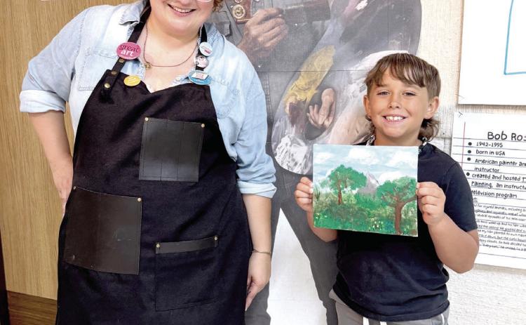 Sylwia Partyka, Director of Development at the Mabee-Gerrer Museum of Art, poses with Tanner Duff, 8, of Bethel during the Art Mania event held on Tuesday. The Bob Ross-themed event was free, full of 'happy trees' and open to all ages! Photo provided