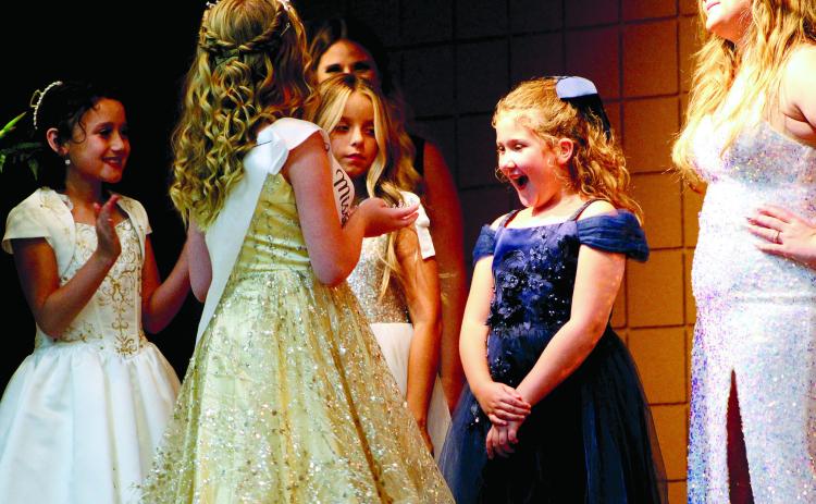 Callie Jane Hart, 8, reacts with surprise at being presented the crown for Junior Miss Frontier Days by 2021 Junior Miss Contessa Boatman during the Pageant on Sept. 11 at Tecumseh City Hall Auditorium. Also shown are Junior contestants Ember McPherson, 9, and Paetyn Fields, 10. Countywide & Sun/Natasha Dunagan