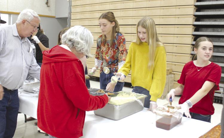 Tecumseh eighth-grade FFA members Emma Rodgers, McKenzie Benge and Madi Taron serve those attending the Tecumseh High School FFA Pig Roast on Nov. 17. Countywide & Sun/Natasha Dunagan