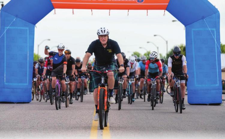 spOKeLAHOMA owner Craig MacIntyre (in the kilt) leads the racers out to start the Fenrir Unchained Bike Race in Tecumseh on June 4. MacIntyre said this was a good first year with 85-90 riders participating. Photo provided.