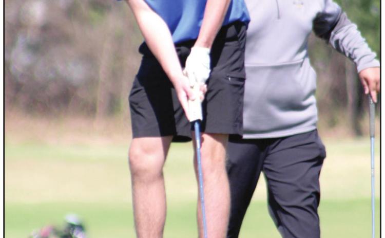 Bethel sophomore Campbell Freed putts at the seventh hole, as Bryscon Cosper, a Tecumseh sophomore, waits his turn during the tournament, on April 14.