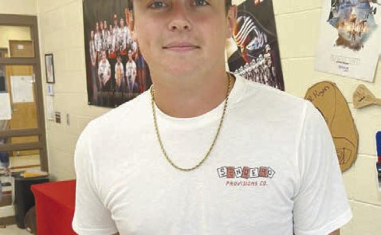 Right: Braden Ueltzen poses with his Archery State Championship ring. Ueltzen placed second in high school boys at the State Tournament but was unable to attend Nationals due to a conflict with NRC baseball state playoffs. He will be attending USAO in Chickasha this fall on a baseball scholarship. Photo Provided