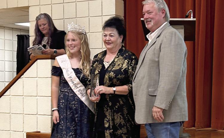 Suzanne and Randy Gilbert received the very fist Impact Award at the Tecumseh Chamber Annual Meeting and Awards Banquet held Tuesday, Nov. 14. The Gilberts are posing with 2023 Miss Frontier Days Alleigha McCullough. Countywide &amp; Sun/Suzie Campbell