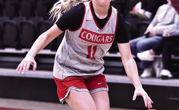 North Rock Creek’s Aubree Shivelhood brings the ball up court. Photo courtesy of Gowin Photography
