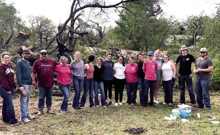Tecumseh FFA members and advisors pose for a photo while helping with cleanup at the Lindsey/Rawlins property after the tornado on April 19. Photo provided