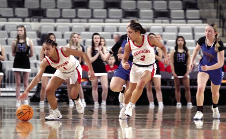 McLoud juniors, twins Chloe and Claire Mapira, take the ball up court during the Class 4A State Quarterfinal game against Harrah, at the OG&E Coliseum in OKC on March 10. The Lady Redskins won, 44-30, and advance to the Semifinals today (March 12) at 6 pm in Yukon. If they win, they will move on to the Finals on Friday, March 13, at 7:45 pm, back at the Coliseum. This is the Lady Redskins first ever State playoff run. Photos by Natasha Dunagan, Countywide & Sun
