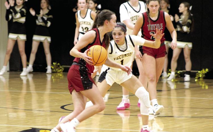 Tecumseh senior Serenity Jacoway keeps her eyes on the ball while on defense during the first home game against Tuttle, Nov. 28. The Lady Savages lost, 26-46. The Savages also lost, 62-72.