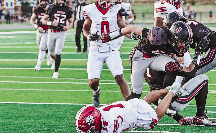 North Rock Creek's Cooper Standlee slips past three defenders to score a touchdown.. The team got a 28-17 win over Crossings Christian Friday, Sept. 4.. They will travel to Harrah tomorrow night. Photo courtesy of Gowin Photography