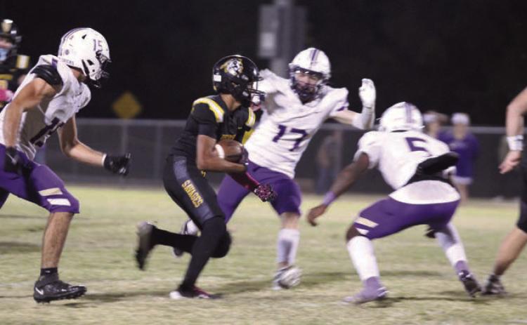 Tecumseh junior Jekhi Owens makes his way around a few Chickasha defenders during the district home game on Oct. 25. The Savages lost in overtime, 41-47. Countywide &amp; Sun/Natasha Dunagan