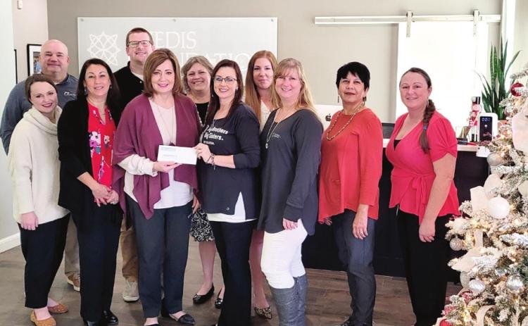 Kathy Laster, Ph.D. President and CEO Avedis Foundation presenting the grant check to Nikk Rieves, Shawnee Area Director joined by members of the Big Brothers Big Sisters Local Resource Board: Mary Belle Zook, Jeff Chamblin, Vivian Lozano-Stafford, Lane Howard, Jennifer Siestema, Lisa Watson &amp; Leslie Merritt and Avedis Staff Tracy Meeuwson &amp; Cheyenne Pettigrew. Photo provided