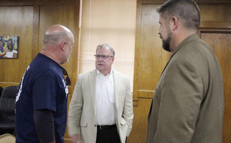 Ron Stearns speaks with Athletic Director Dax Leone, far left, and Superintendent Dr. Aaron Espolt, far right, at the Shawnee Board of Education meeting on Aug. 7. Stearns was hired as the new Executive Director of Operations during the meeting. He has 32 years of experience in education at Mid-Del Schools. Countywide &amp; Sun/Natasha Dunagan