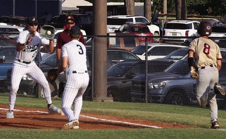 Asher senior Easton Welch makes the catch at first to beat the Drummond runner, as fellow senior Lane Alexander runs in to assist. Photo courtesy of Kent Bush/CPN