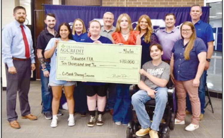Shawnee High School FFA students, along with their teachers and Superintendent Dr. Aaron Espolt, receive a check in August for $10,000 from Oklahoma AgCredit to go toward the FFA program. Photo provided.