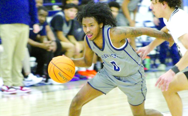 Shawnee junior Daytain Patton drives to the paint in the Jan. 18 Lowe’s/FireLake Arena Shawnee Invitational game with Broken Arrow. The Shawnee Wolves lost that game, 21-60; won the Jan. 19 game with Tahlequah, 57-49; and fell to El Reno, Jan. 20, 37-52.
