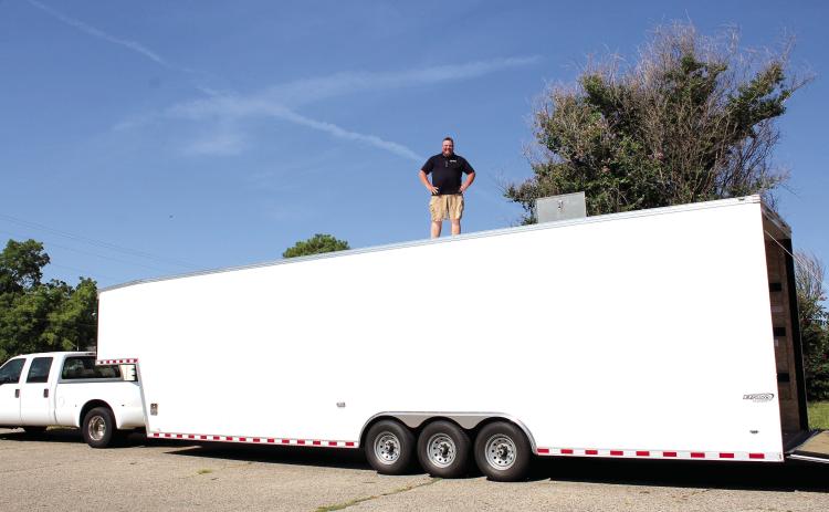 Tecumseh Band Director John Outon stands atop the band's new 9-foot tall, 40-foot long, enclosed gooseneck trailer on Aug. 3. Outon is thankful to everyone involved in approving the purchase of the trailer, which was paid for with the 1/2-cent Pottawatomie County sales tax. Countywide & Sun/Natasha Dunagan