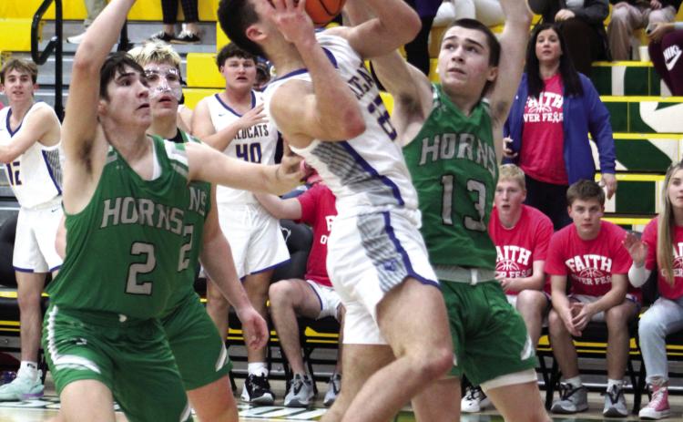 Bethel junior Bray Bussell tries for a basket in the last few seconds of the Jones game and draws the foul on Feb. 13. The Wildcats won by one point, 56-55. On Feb. 17, they beat Okmulgee to win Districts, 65-63. Today (Feb. 23) they will play at Prague in Regionals at 7:30. Countywide &amp; Sun/Natasha Dunagan