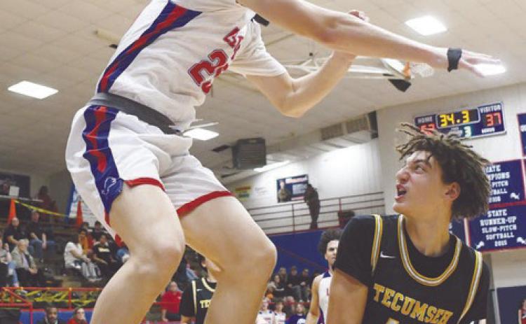 Tecumseh's Cashaw Thompson prepares to make a shot around a Chandler defender in the Jan. 31 away game. The Savages lost, 52-76. Photo courtesy of Brian Blansett