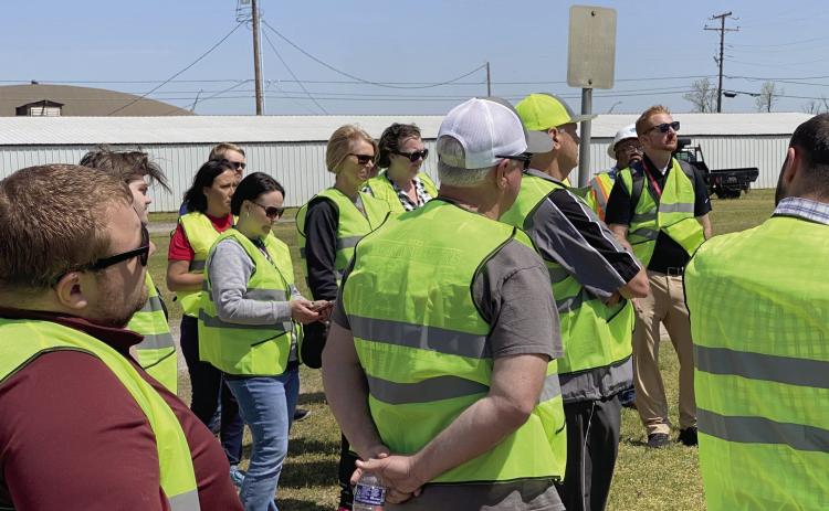 Participants of the Walking Audit in McLoud, held two days before the April tornado, stop to discuss things they have seen that could be changed or could be better. Photo provided