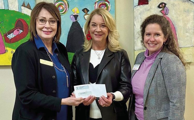 Kathy Laster, Ph.D., President and CEO of Avedis Foundation, presents a check for $15,000 to Miki Farris, Executive Director of Infant Crisis Services, and Allison Parker, Director of Development &amp; Communications of Infant Crisis Services. Photo provided.