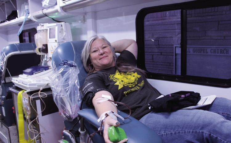 Tecumseh Chamber of Commerce Executive Director Kim Elliott makes her donation on the Oklahoma Blood Institute Bloodmobile during the Tecumseh Community Blood Drive on Dec. 19. Elliott has donated 30 times and said the Chamber changed the blood drive from annual to every two months when she took the job. Elliott added that OBI joined the Chamber in December. Natasha Dunagan, Countywide & Sun