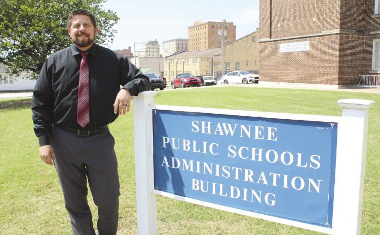 New Shawnee Superintendent Dr. Aaron Espolt stands by the Administration Building sign on July 27. Espolt said Shawnee Public Schools continue to recover from the April 19 tornadoes. They also plan to have more transparency and communication with the public this year. Countywide &amp; Sun/Natasha Dunagan