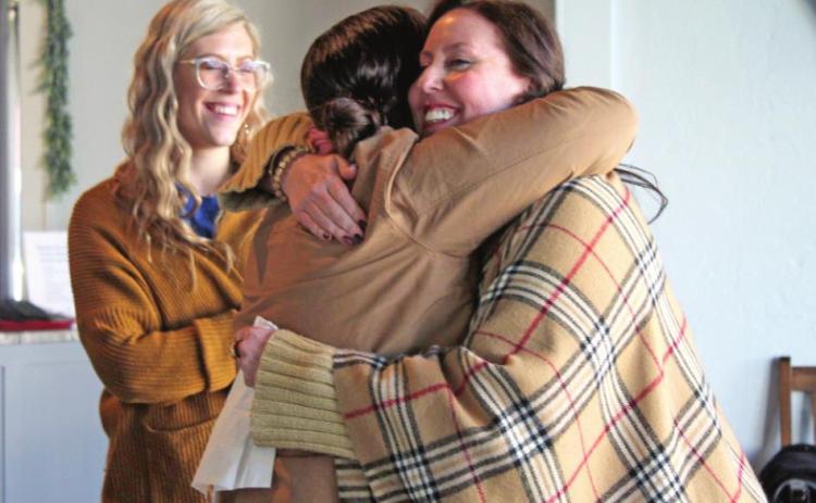 Nicole Sanchez and Renah Coffman have a hug after sharing their stories of loss, as Korie Perez looks on, during the Blue Zones Project Women’s Purpose Empowerment Brunch at Healthy Hive Nutrition in Shawnee on Feb. 12. Countywide &amp; Sun/Natasha Dunagan