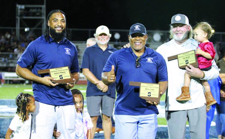 Jackson Winrow, Walter Cudjo and Coach Billy Brown were inducted into the Shawnee Football Hall of Fame during halftime of Shawnee’s first home game on Sept. 13. Winrow, Class of 2016, is joined by his twin daughters, Alani and Jaielle, 4. The late Walter Cudjo’s son, Anthony Derone Cudjo, accepted his plaque. The elder Cudjo was in the Class of 1959. Brown, holding his grandson Archie Kin, 17 months, was a football coach at Shawnee from 2004 to 2019. Countywide & Sun/Natasha Dunagan