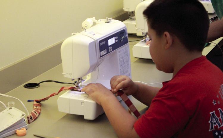 Pottawatomie County 4-H Club member Gavin Klippenstine sews a lanyard during the "Fair Project Day" meeting, held at North Rock Creek High School on Aug. 4. Kortni Perkins, 4-H educator, said they had 27 members working on projects to enter in the Pottawatomie County Free Fair. Photos courtesy of State 4-H Secretary Mason Luka