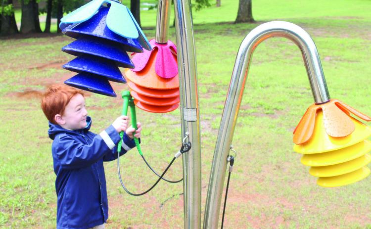 Frankie Lewis, 3, of Macomb plays the Rainbow Chimes on the Pioneer Library System Music Trail. Tecumseh Public Library had a ribbon cutting on April 25 for six new instruments, located along the northern trail of Slick Humphrey Park. Lewis's mother, Abigail Lewis, said her and her four children come to the park all the time. Natasha Dunagan, Countywide & Sun