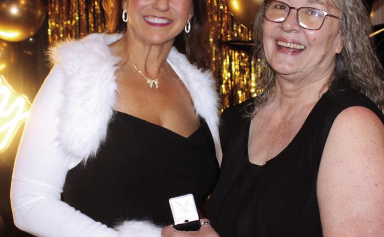 Rachael Melot, left, accepts a lapel pin from Countywide & Sun Publisher Suzie Campbell for placing eighth on the Pottawattomie Power Poll, during the Awards Gals on Oct. 24. Natasha Dunagan, Countywide &amp; Sun