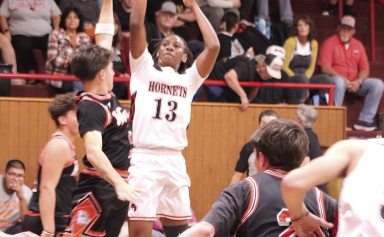 Macomb's Deandre Hendley aims for a three-pointer during the Nov. 18 home game against Wayne. The Hornets won 61-59.