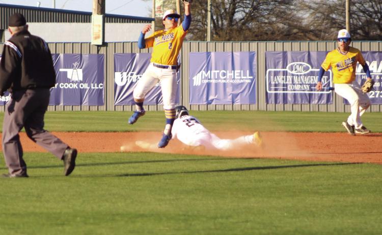 Shawnee's Zane Wilson steals second base as a Will Rogers players jumps for the ball in the first inning of the home game on March 28. The Wolves won, 10-0. Countywide & Sun/Natasha Dunagan