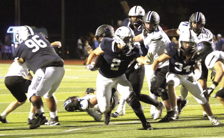Shawnee junior Riley Storie blocks the Newcastle defense on his way to making a touchdown during the first half of the Sept. 25 homecoming game. The Wolves lost, 14-62. Natasha Dunagan, Countywide &amp; Sun