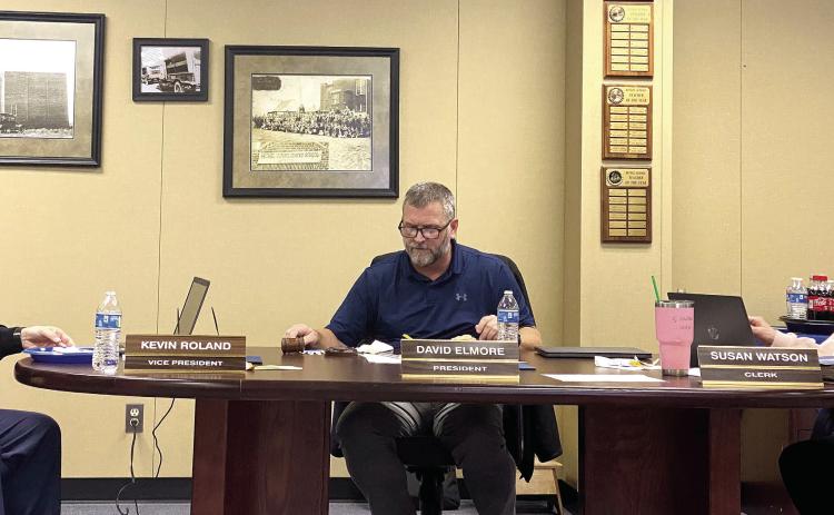 Kevin Roland (left), David Elmore (center), and Susan Watson (right) review bid information presented for the sale of bonds during the special meeting of the Bethel School Board held Monday, Jan. 23. Countywide &amp; Sun/Suzie Campbell